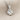 Heart clover pendant, polished silver finish, front view on fabric