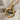 Close-up of the handcrafted circular nail pendant showing detailed pavé stone setting on the head and tip