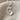 Mother Baby Footprint Pendant, polished, front view on textured fabric