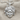 Gorgon Medusa Pendant, polished silver, front view with chain on fabric