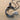 Twin Bird Letter C Pendant, black rhodium plated, product photo on sand