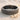 Grooved Band Ring, oxidized silver, angled product photo on beach sand