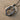 Bird Letter O Pendant, black rhodium, on sand and shell