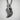Resting Swan Pendant, oxidized silver, hanging on chain against wall