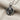 Clawing Lion Pendant in oxidized silver, high-angle view on woven linen