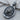 Sterling silver Leo zodiac pendant with patterned bail and engraved text shown angled on a textured wooden surface