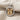 Angled view of luxury astrological Gemini twins pendant highlighting the detailed gold-tone figures and silver ring