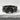 Overlapping Pebble Ring, black rhodium plated, front view on white stone