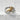 Detailed close-up of the Aries ram ring on white stone, highlighting the intricate gold tone and oxidized silver terrain.
