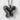 Double Wing Butterfly Pendant, black rhodium plated, front view on textured surface
