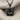 Layered Lotus Pendant, black rhodium, front view on fabric