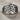 Embracing Wings Ring, angled three-quarter view on linen