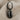 Cowrie Shell Earring in black rhodium, product photo on fabric