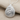 Spiral Conch Pendant, polished silver, angled view on fabric