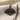 Hand fan pendant, black rhodium, angled view on textured fabric