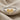 Petite Bow Ring, two-tone, front view on textured fabric