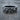 Detailed 925 silver floral skull ring resting on a textured wooden stump highlighting the dark oxidized silver finish.