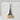 Close-up of the intricately detailed Tokyo Tower pendant resting on a textured white stone block surface
