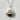 Close-up of the handcrafted oxidized silver salmon onigiri pendant resting on a textured white surface