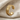 Side profile of the Urartu Griffin Cuff Earring resting on textured fabric highlighting the continuous engraved design