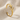 Close-up of the oxidized silver deer antler cuff earring resting on textured fabric highlighting the tines