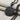 Peace Love Pendant, black rhodium plated, angled view on fabric