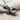 Microphone Fist Pendant, oxidized silver, angled view showing thumb and fingers gripping mic