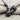 Grip Barbell Pendant, black rhodium, angled view on fabric chain