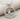 Sailboat Wave Pendant, polished silver, front view on fabric