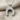 Inverted Horseshoe Pendant, polished silver, on chain against fabric background