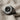 Audio Speaker Ring, black rhodium plated, angled view on textured fabric