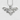 Handcrafted oxidized silver bat wing pendant resting on a textured white surface showing detailed silver bail