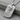 Memento Mori Dog Tag Pendant, polished silver, angled view on stone