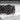 Extreme close-up of Art Deco ring showing hand-finished palmette scrollwork and dark oxidized contrast