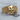 Spread Wing Skull Ring, gold vermeil, front view on wood surface