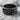 Overlapping Dragon Scale Ring, black rhodium, front view on rock surface