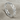 Eternity interlinked heart ring in polished silver, angled front view on fabric