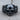 Scroll Skull Ring, black rhodium, front product view on wood