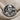Benjamin Franklin Ring, oxidized silver, front view on textured fabric