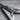 Flying V Electric Guitar Pendant, oxidized silver, close-up of bridge and pickguard