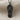Flip Flop Pendant, black rhodium plated, front view on woven textile