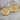 Gothic dragon cross cufflinks, gold vermeil, angled view pair on stone