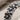 Slim blossom eternity ring, oxidized silver, close-up of petal details