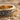 Vintage Scrollwork Wedding Ring, close-up view of botanical scroll relief on sand