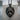 Openwork Tiger Head Pendant, black rhodium, product photo on stone pedestal
