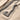 Braided Viking Axe Pendant, oxidized, angled view on sand