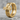 Flared Gothic Cross Earring, gold vermeil, angled product photo on stone