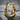 Forge hammered hoop earring, gold vermeil, product photo on stone