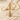 Infinity Ribbon Cross Pendant, gold vermeil, product photo on sand with shells