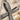 Infinity Ribbon Cross Pendant, close-up of oxidized silver textured ribbon and stones